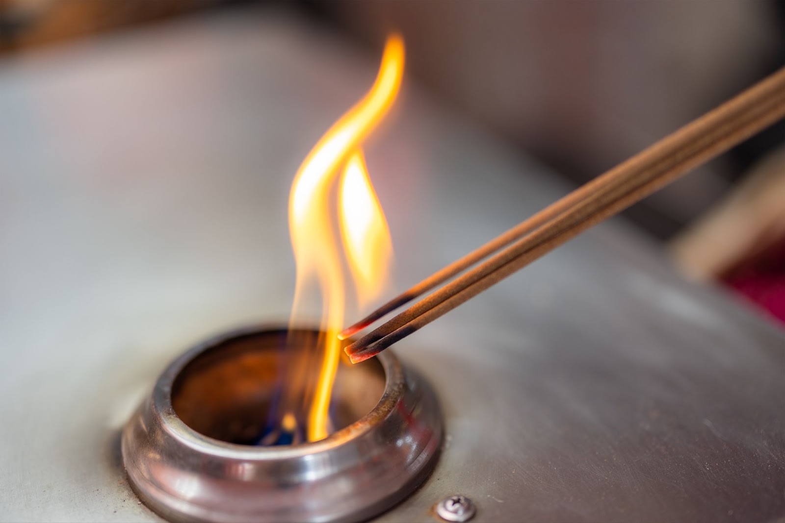 Open flame with incense sticks burning. 