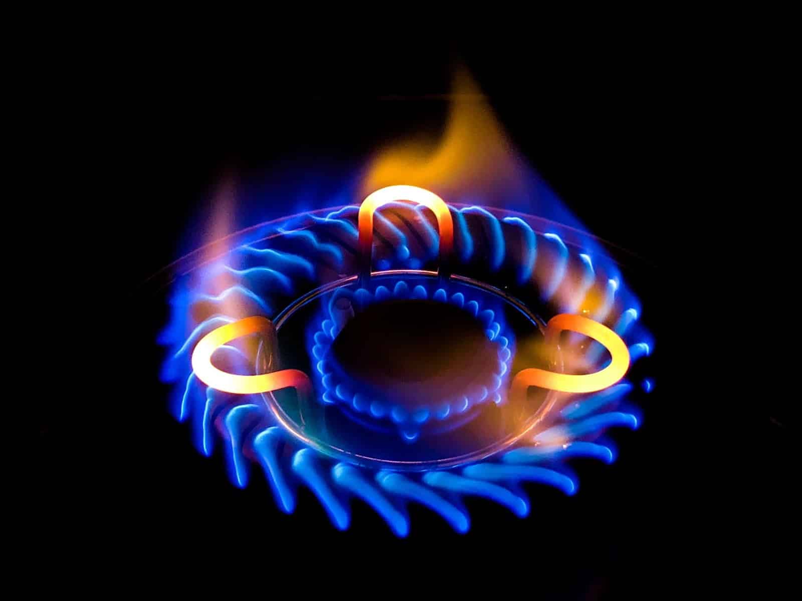 A vibrant close-up of a gas stove's blue flame, symbolizing efficient cooking and a well-maintained propane gas supply.