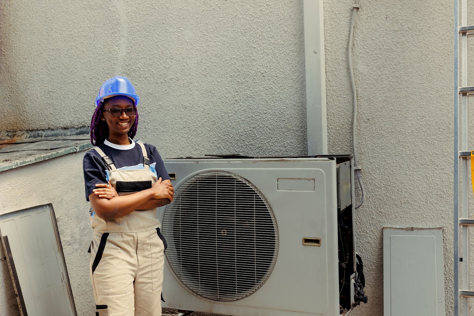 A woman standing in front of an HVAC unit.