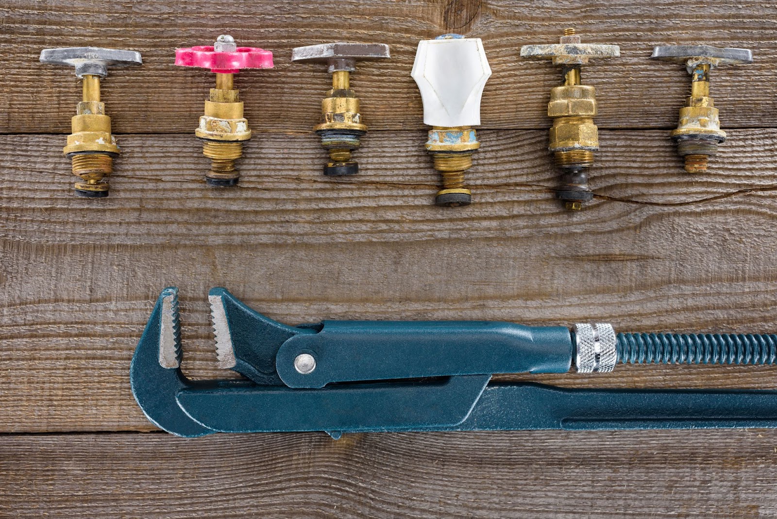 a wrench and several brass valves